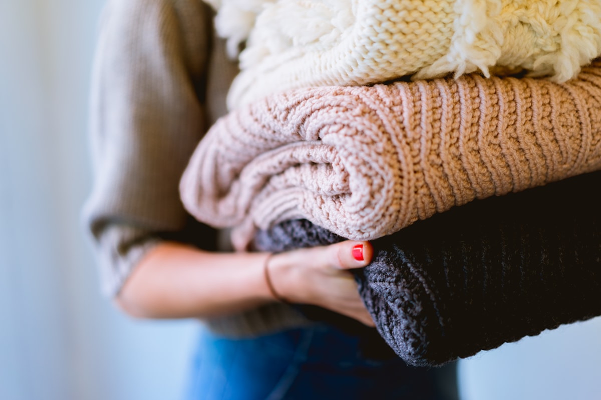 Freshly laundered knits, folded soft and held ready to return to your door